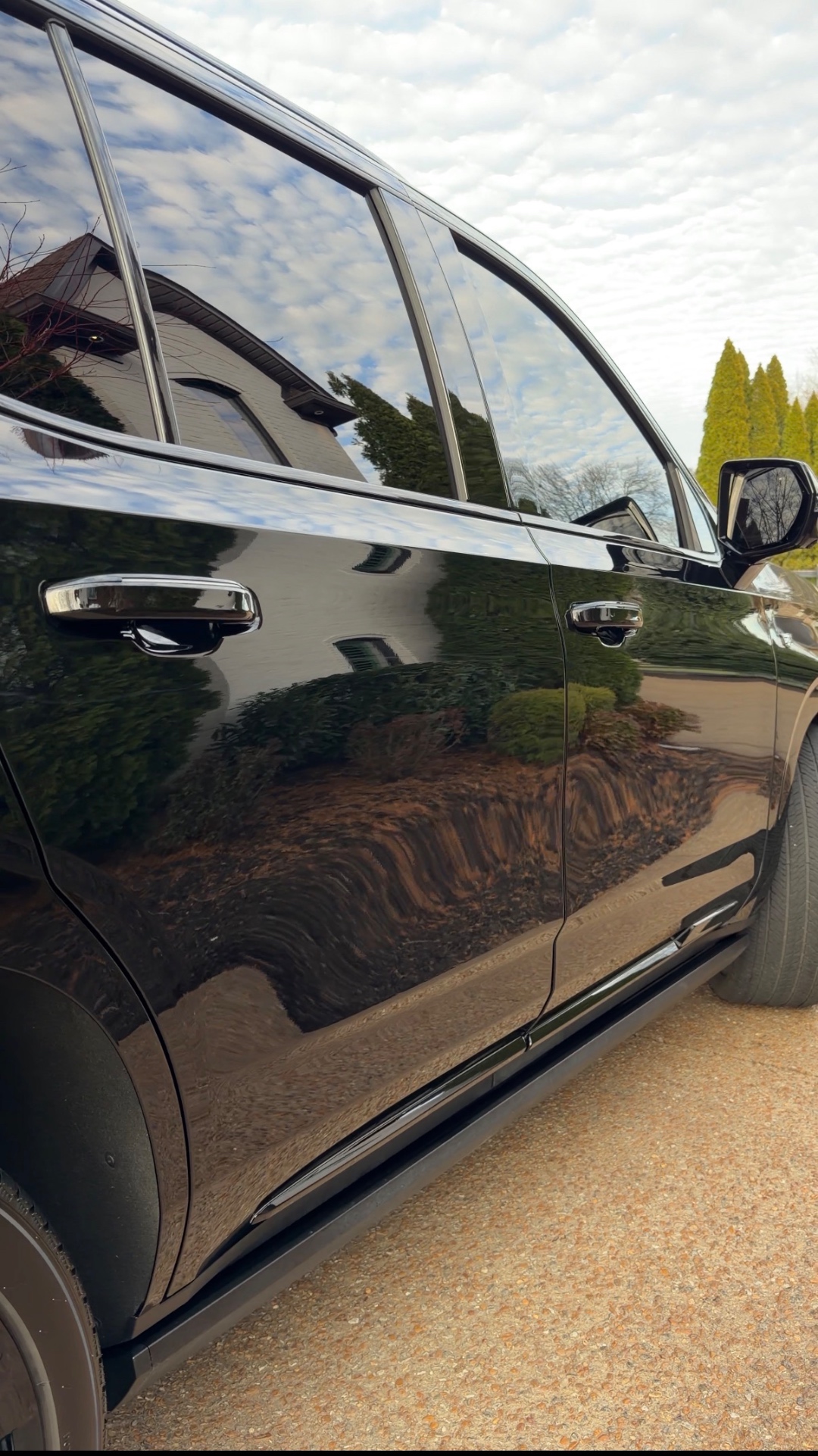 Mirror-like ceramic coated door panel reflecting clouds