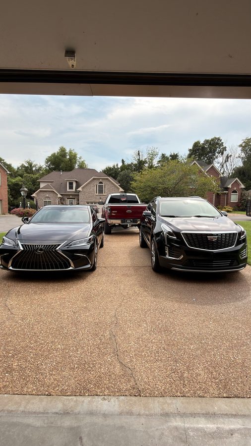 Hitchcock Detailing truck on site between a Lexus ES and a Cadillac XT5