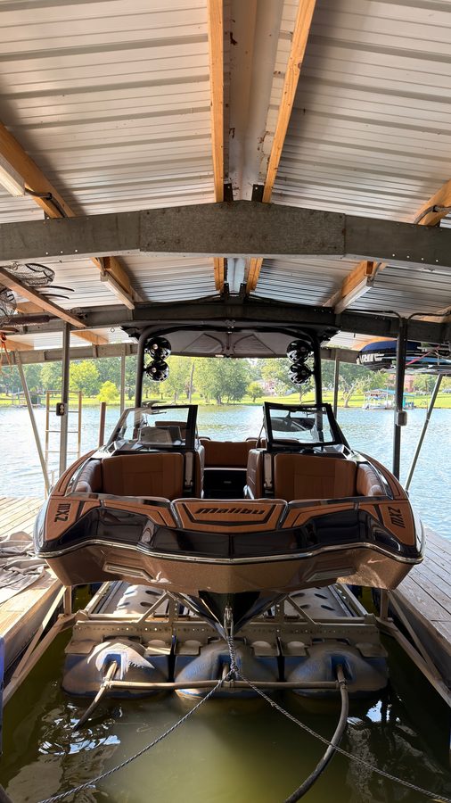 Malibu MXZ wakeboat on its lift after detailing